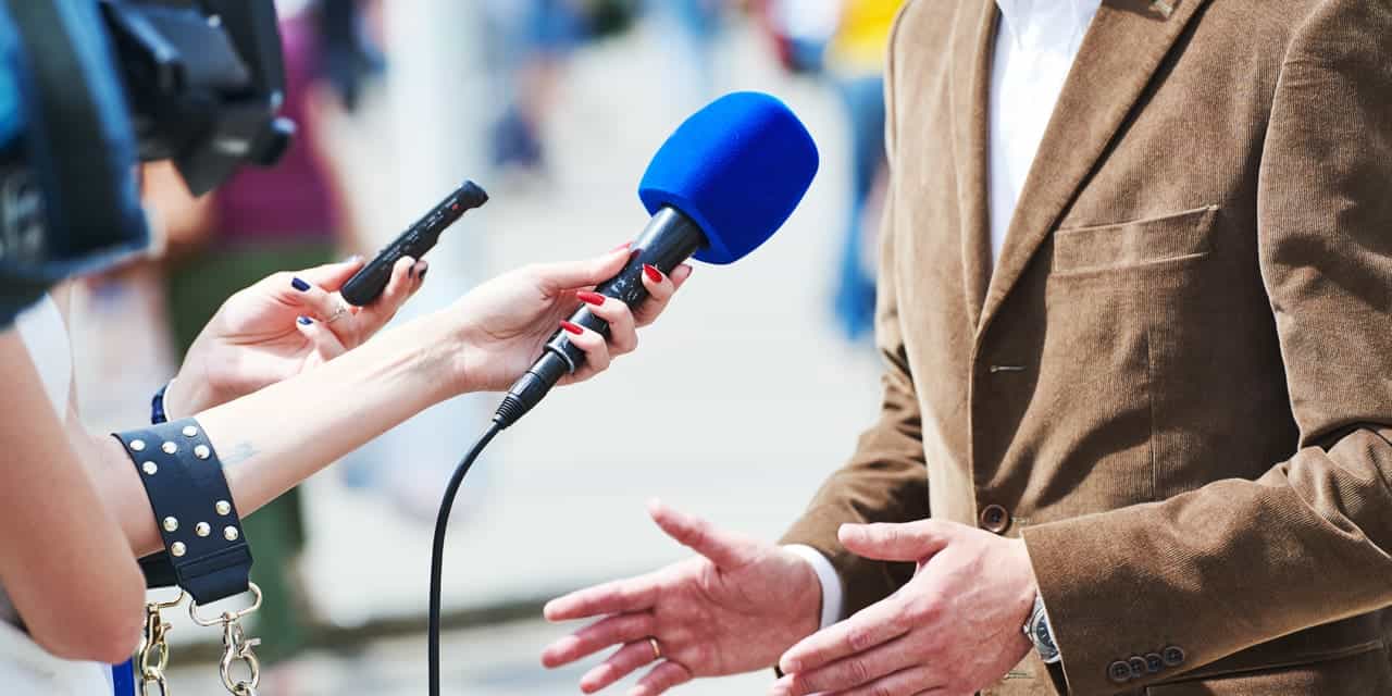 A man being interviewed by the media