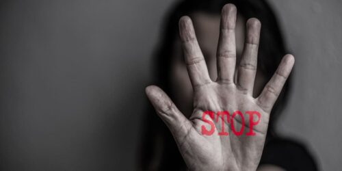 Stop written on a hand