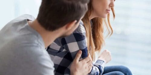 Man and woman sitting on a couch