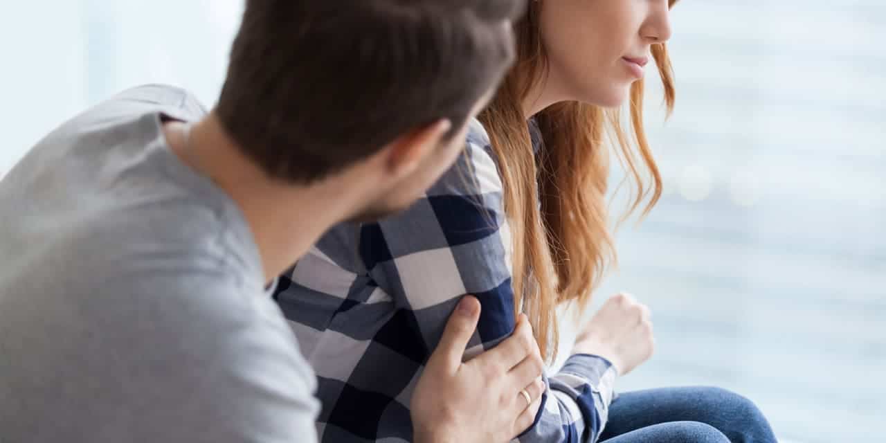 Man and woman sitting on a couch