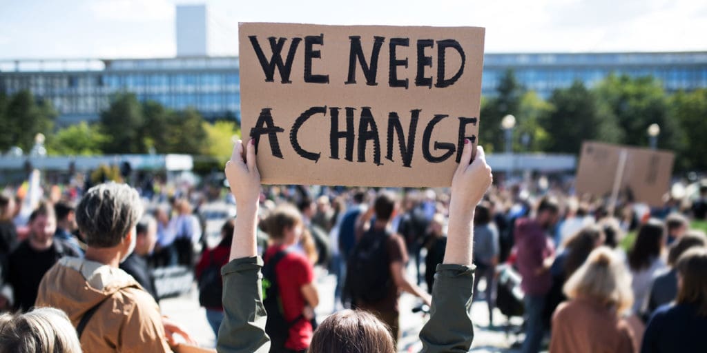 Protestor holding a sign|Anne Ziegler|||||||||||