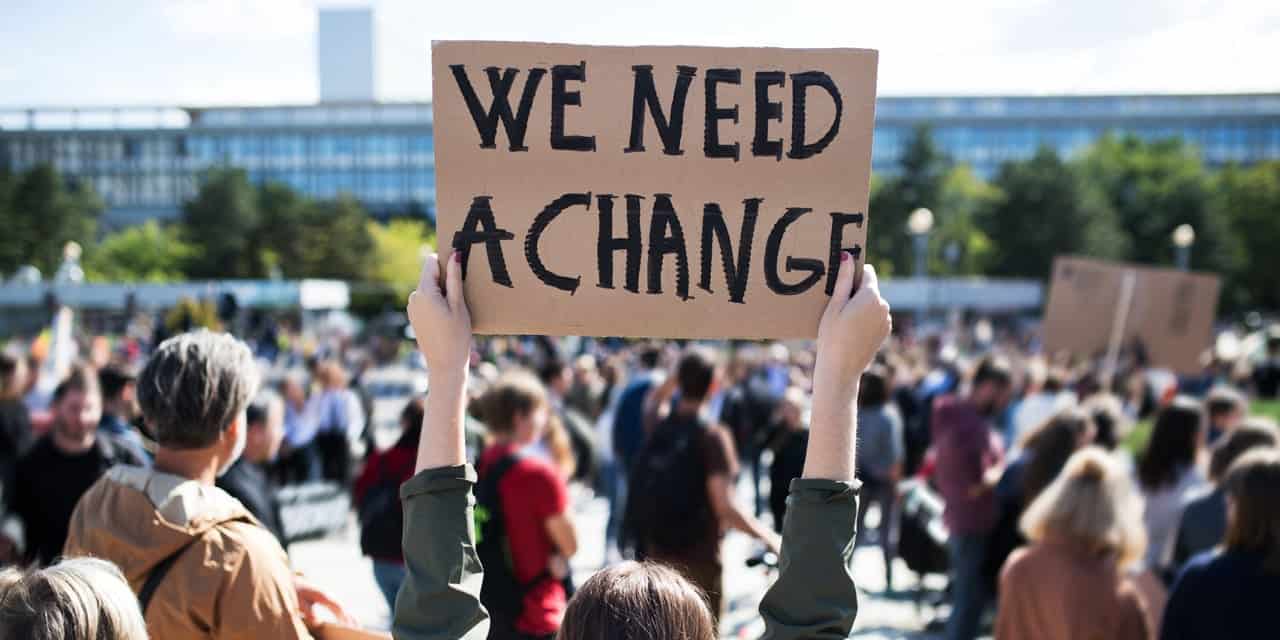 Protestor holding a sign|Anne Ziegler|||||||||||