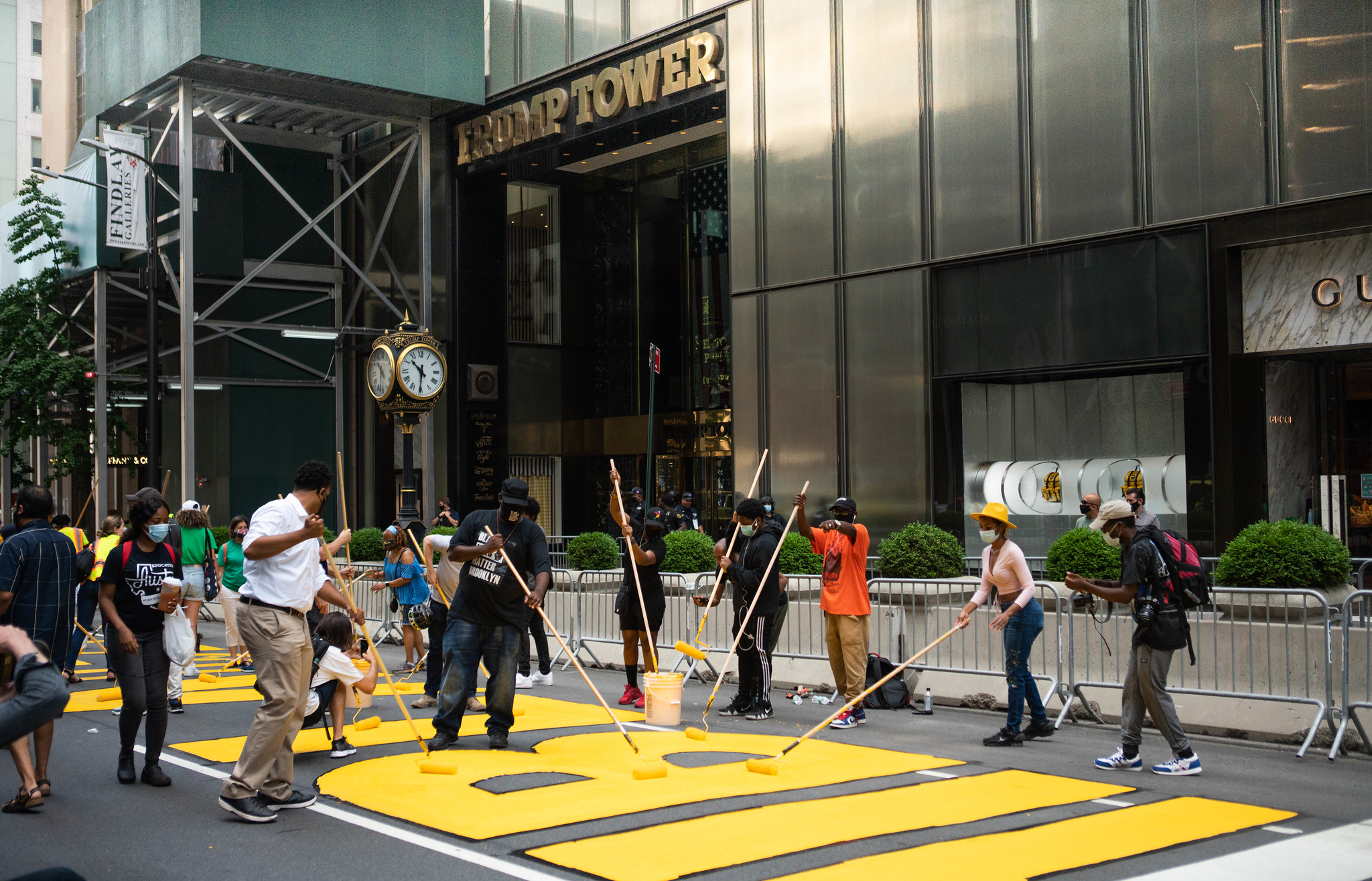 Protestors painting the words "Black Lives Matter" on the street in front of Trump Tower