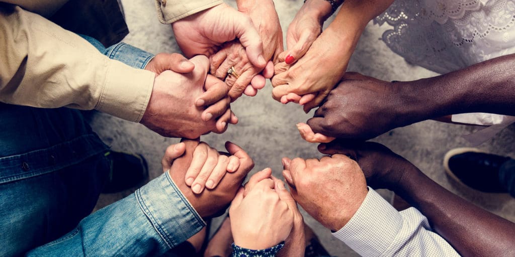 Group of diverse people holding hands