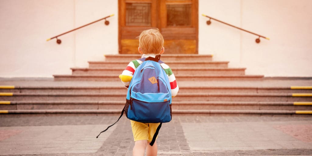 Child walking into school||