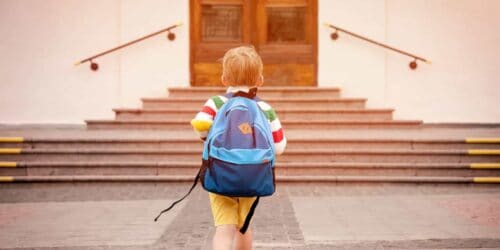 Child walking into school||