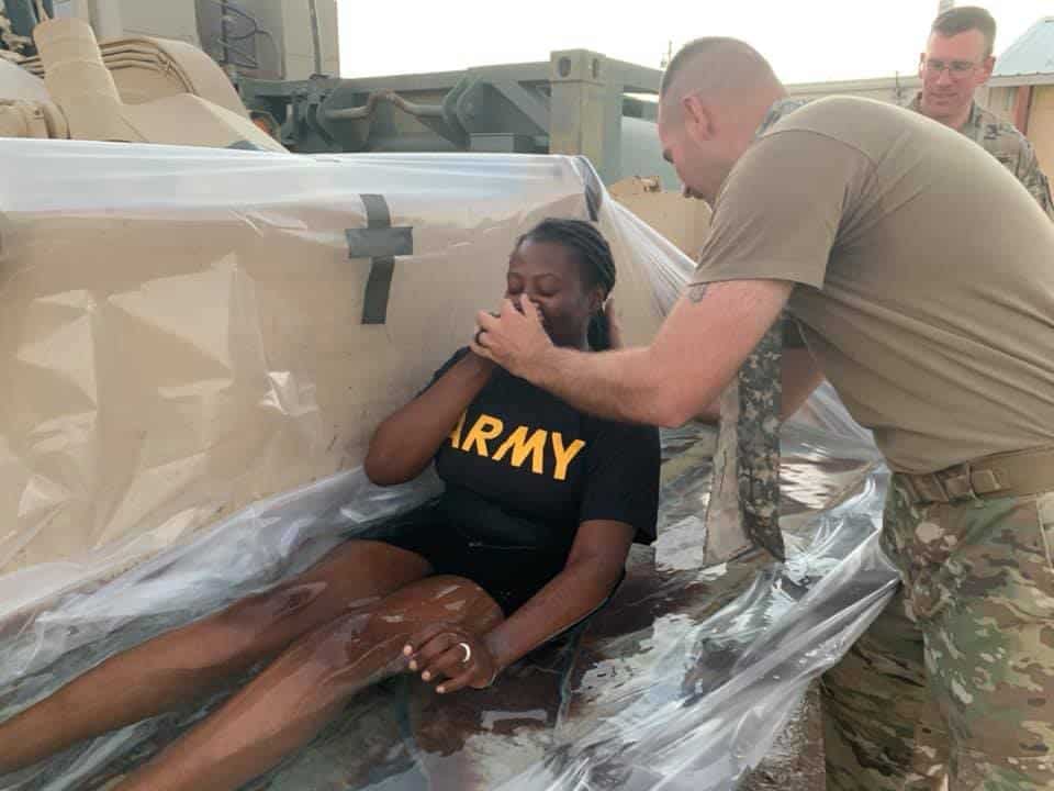 Female Soldier Baptized in a Tractor Bed||Male Soldier Baptized in a Tractor Bed
