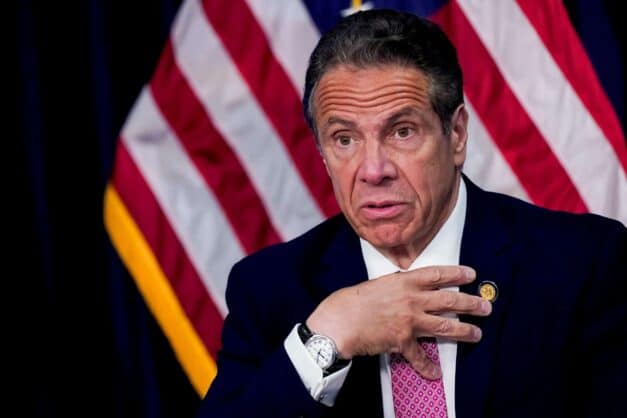 Andrew Cuomo with an American Flag behind him