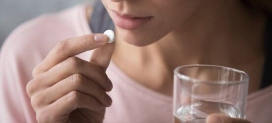 Woman taking a pill