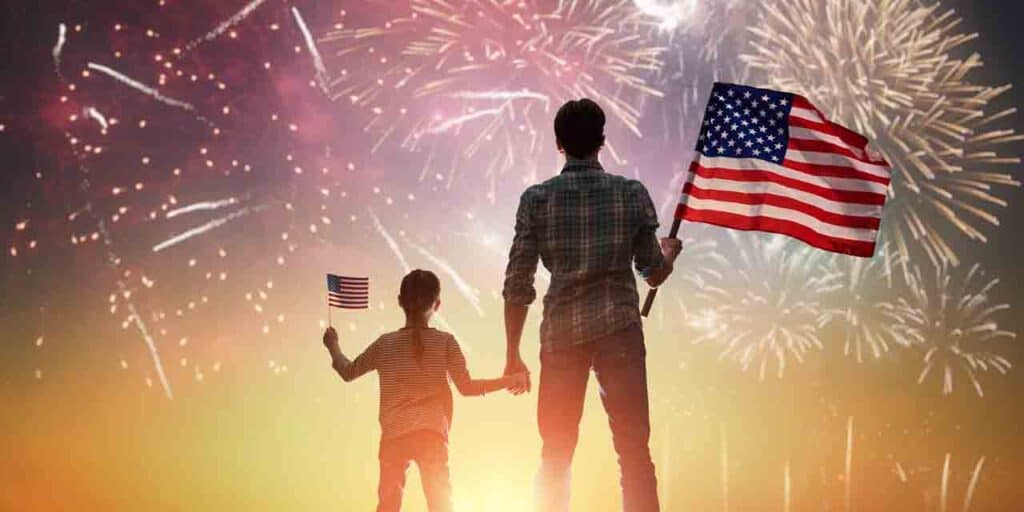 Parent and child holding American flags