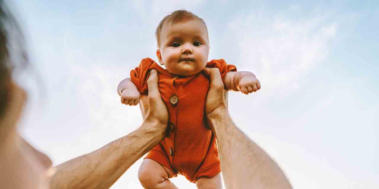 Baby held in the air by a parent