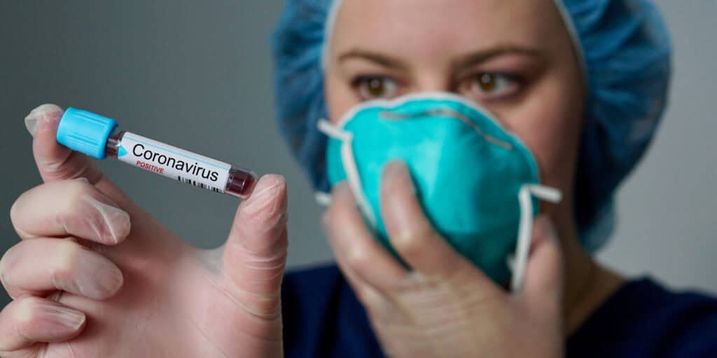 Nurse holding a COVID test