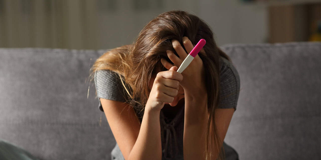 Woman holding a pregnancy test