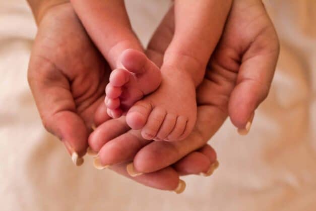 Baby Feet in Mother's Hands