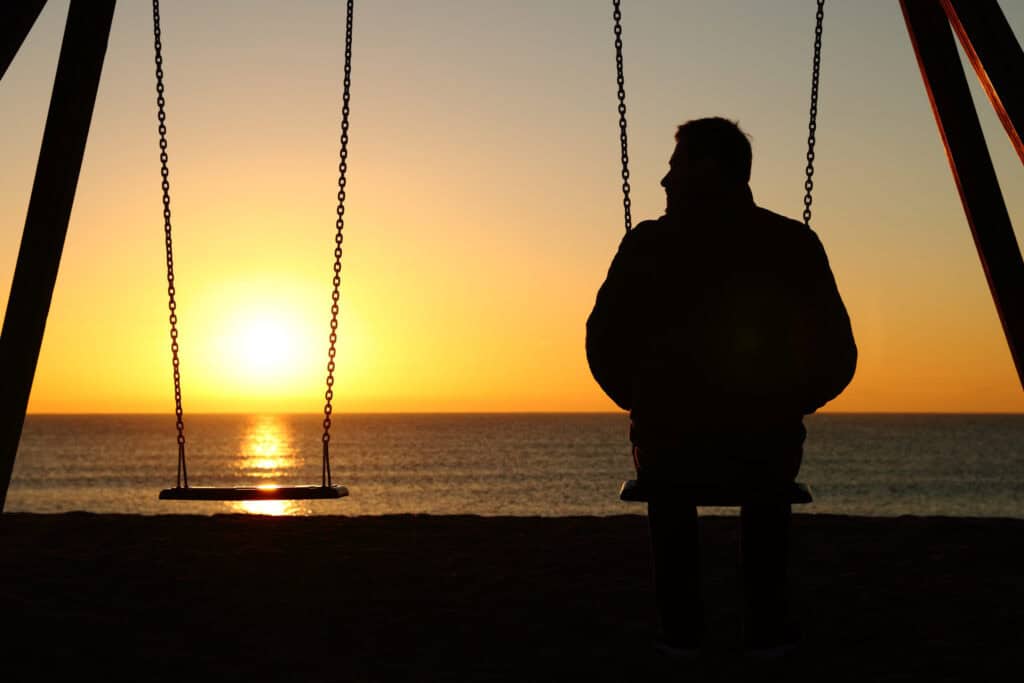 Man Sitting Alone on Swing|