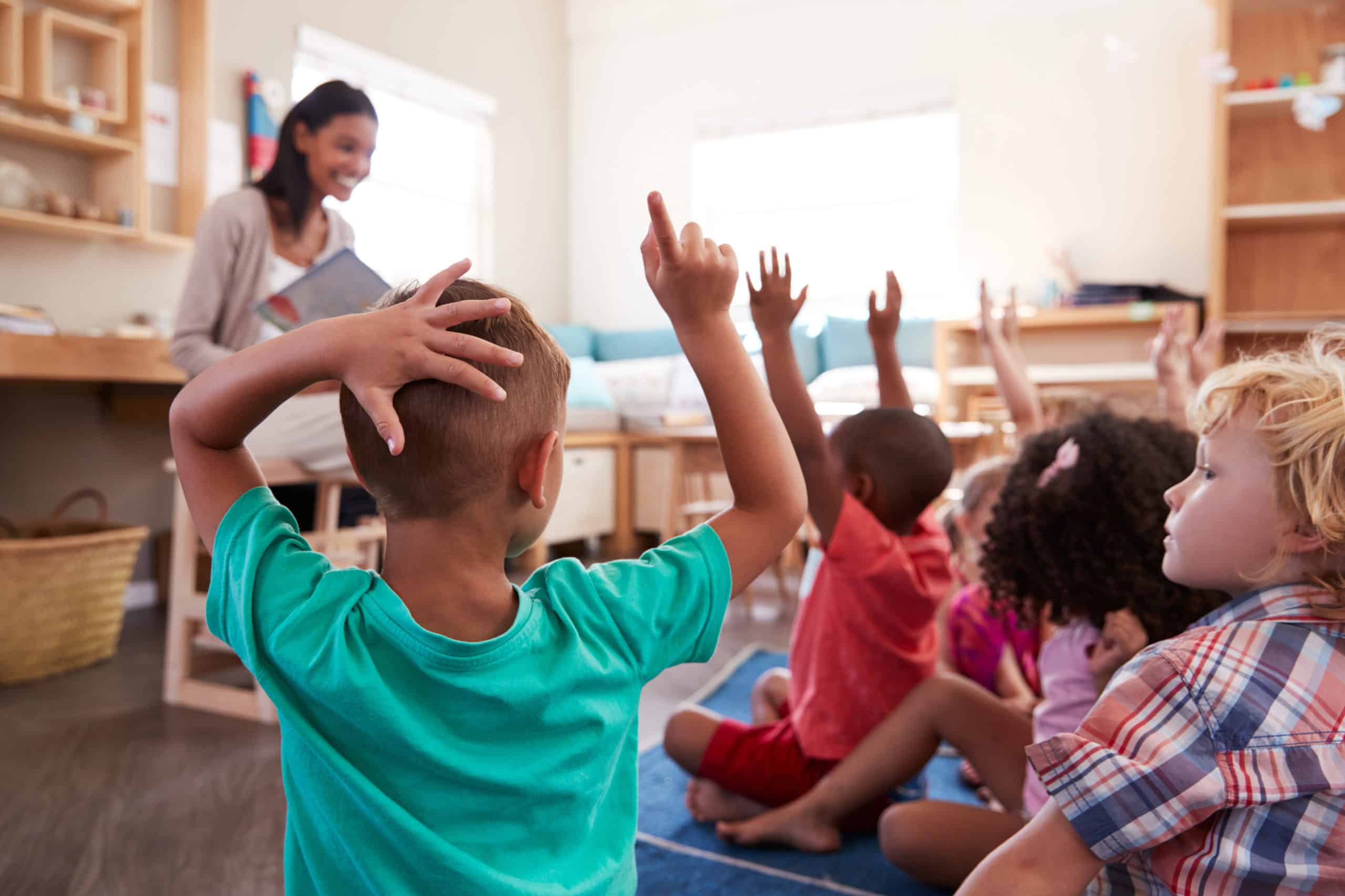 Schoolchildren raising hands